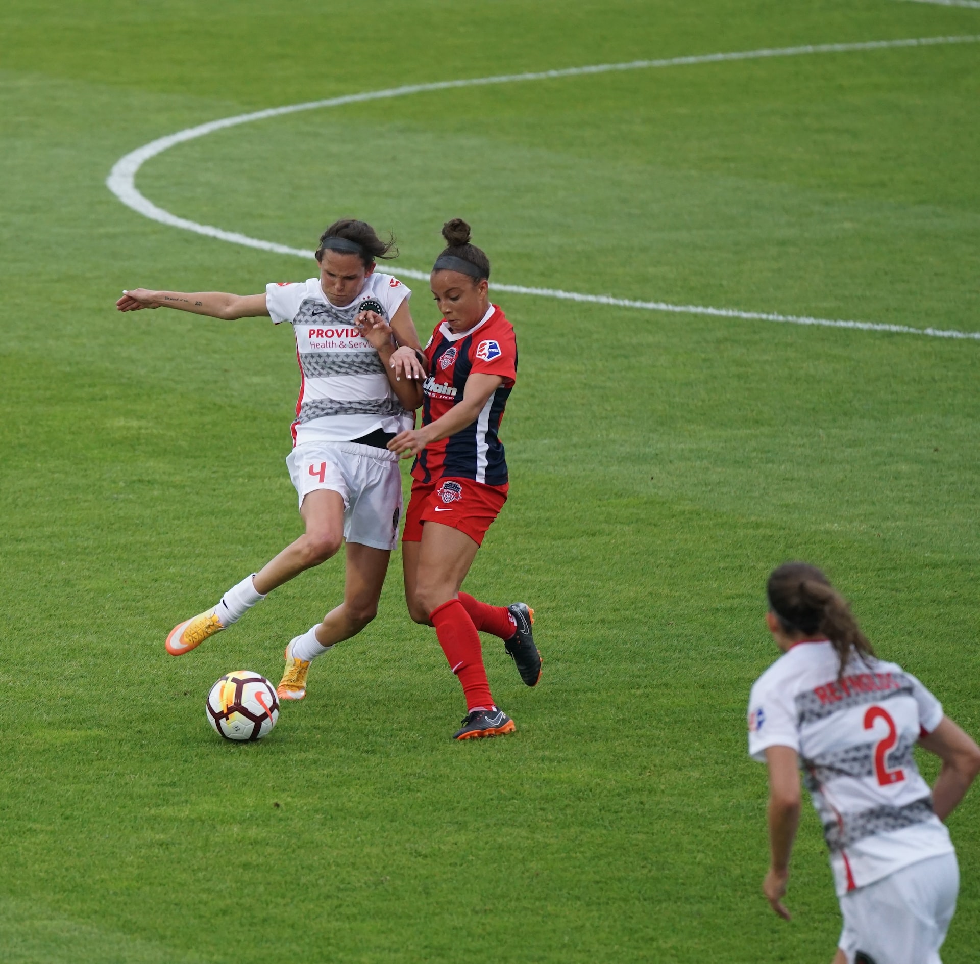 Female players are playing football.
