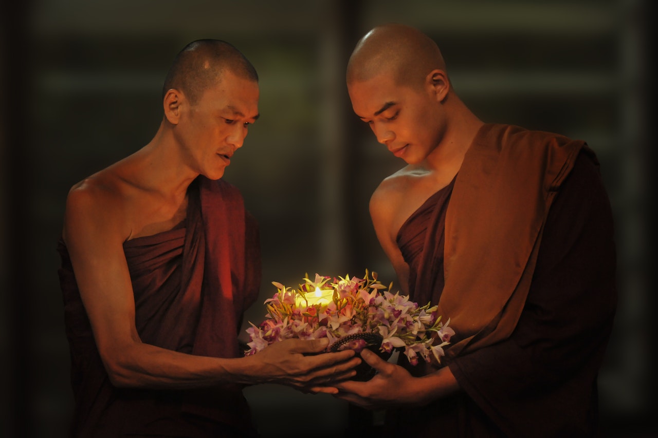 Two Man Monks Holding Light