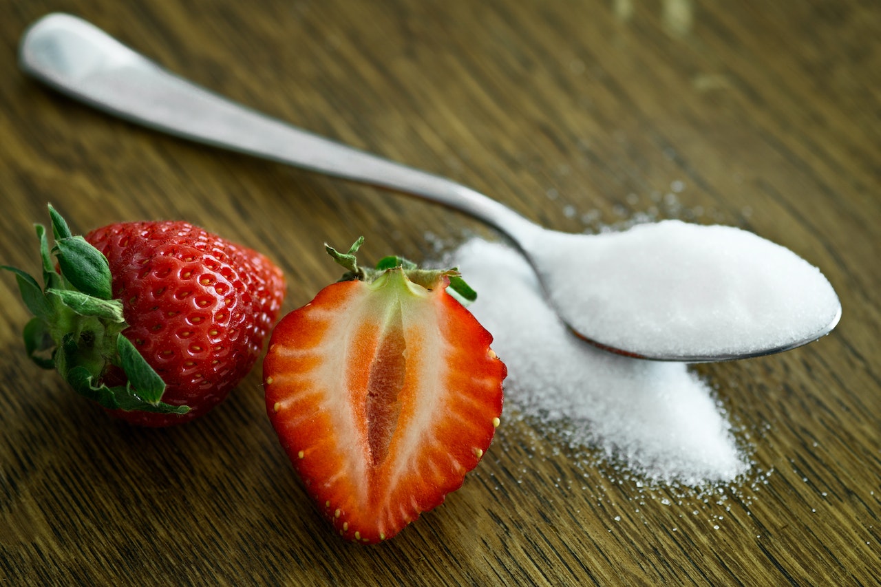 Strawberry Beside Spoon of Sugar