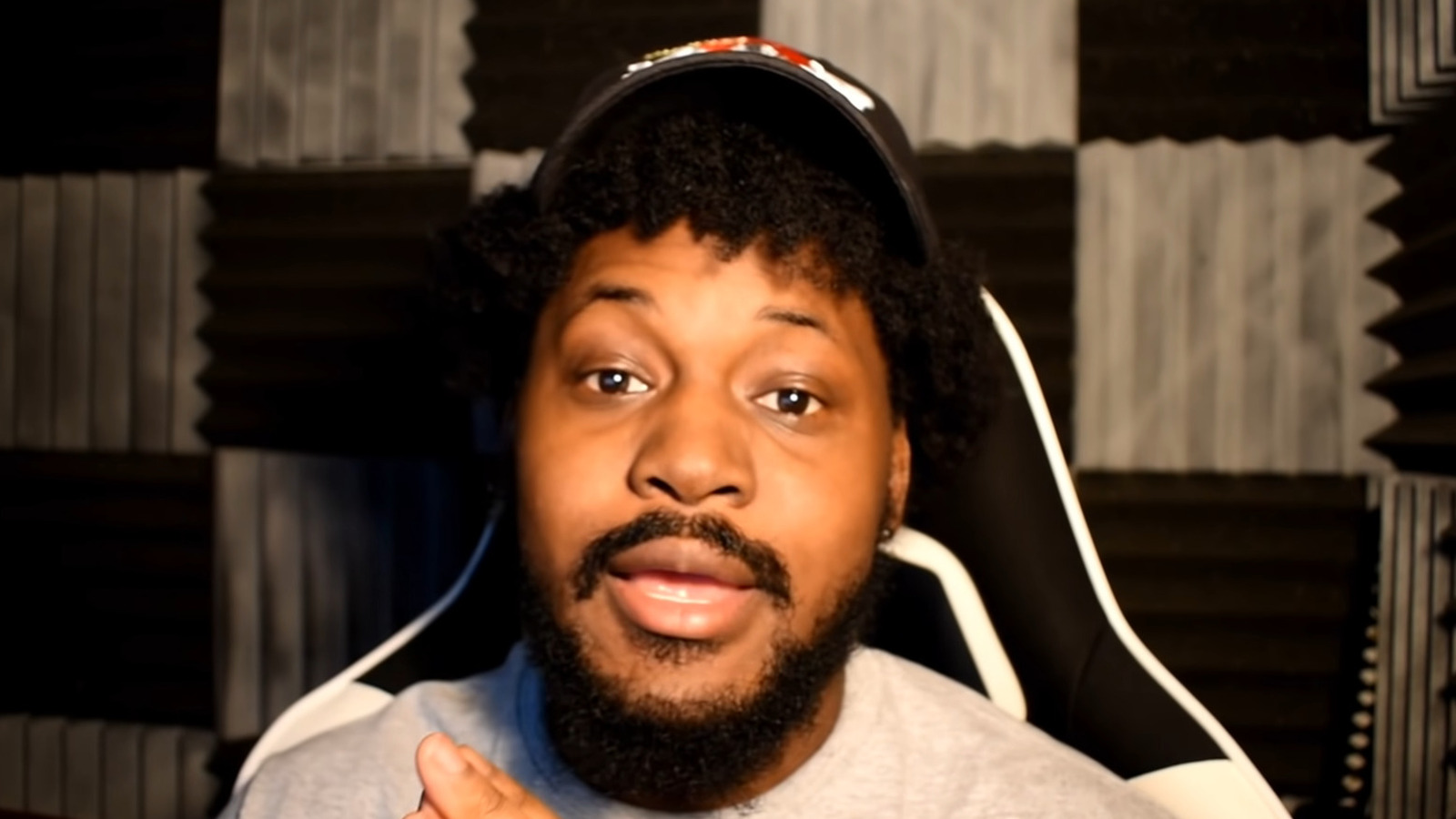 Coryxkenshin sitting on a chair as he speaks during one of his YouTube videos