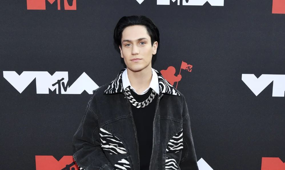 Chase Hudson wearing a black jean jacket at an event