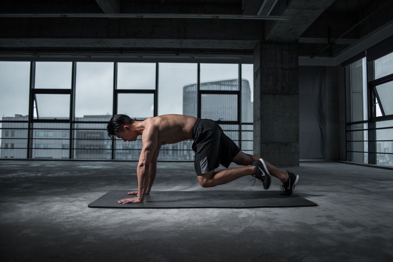 Man Working Out Using Mat
