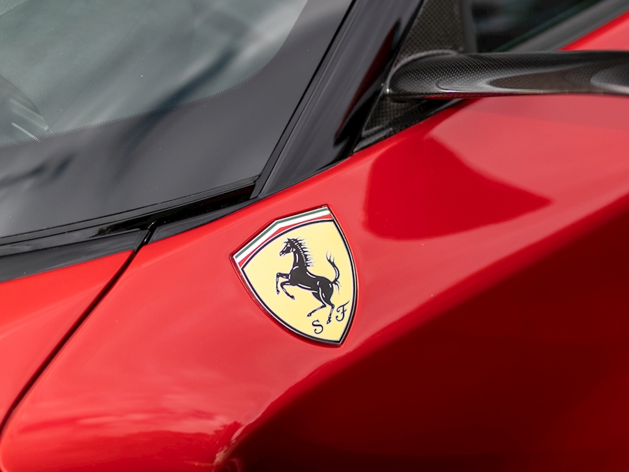 A red Ferrari car showing the Ferrari logo