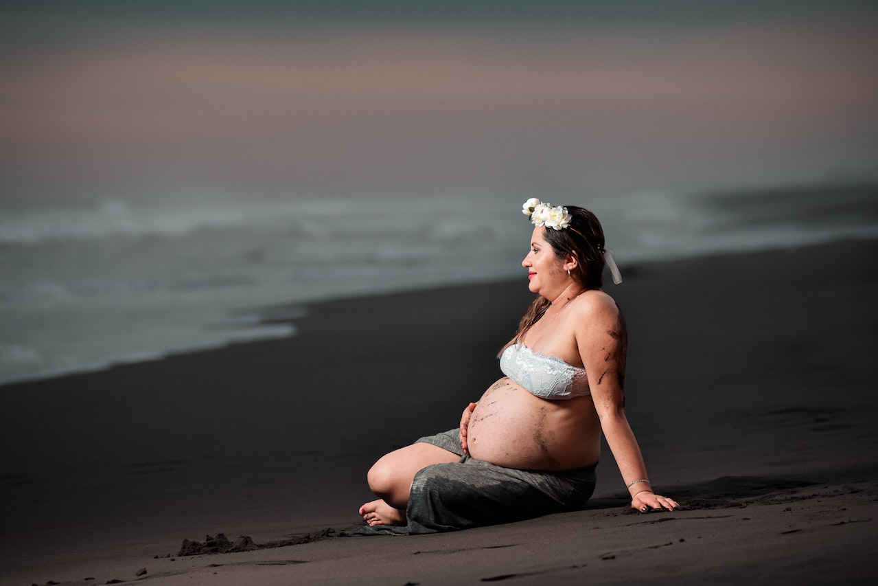 A Pregnant Woman Sitting on the Seashore
