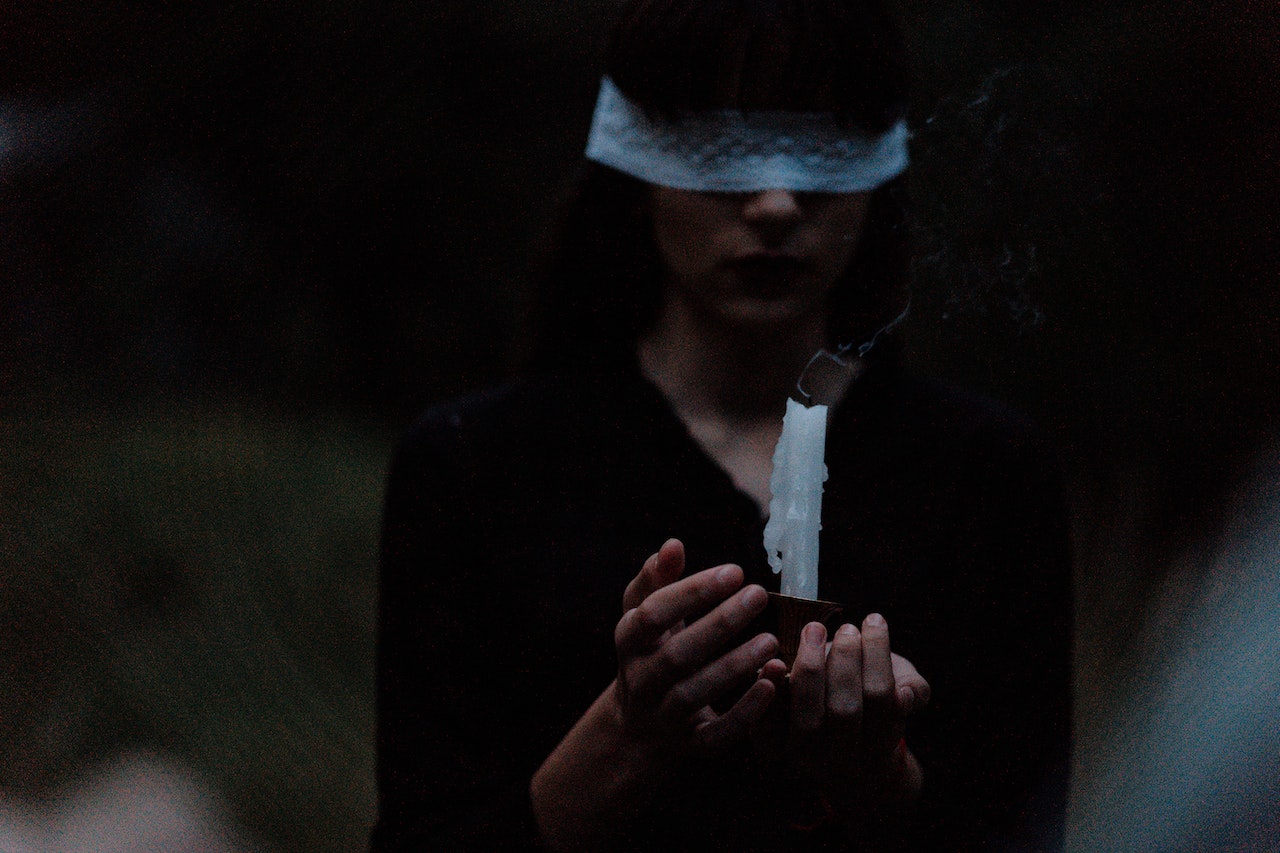 Blindfolded Woman With a Candle