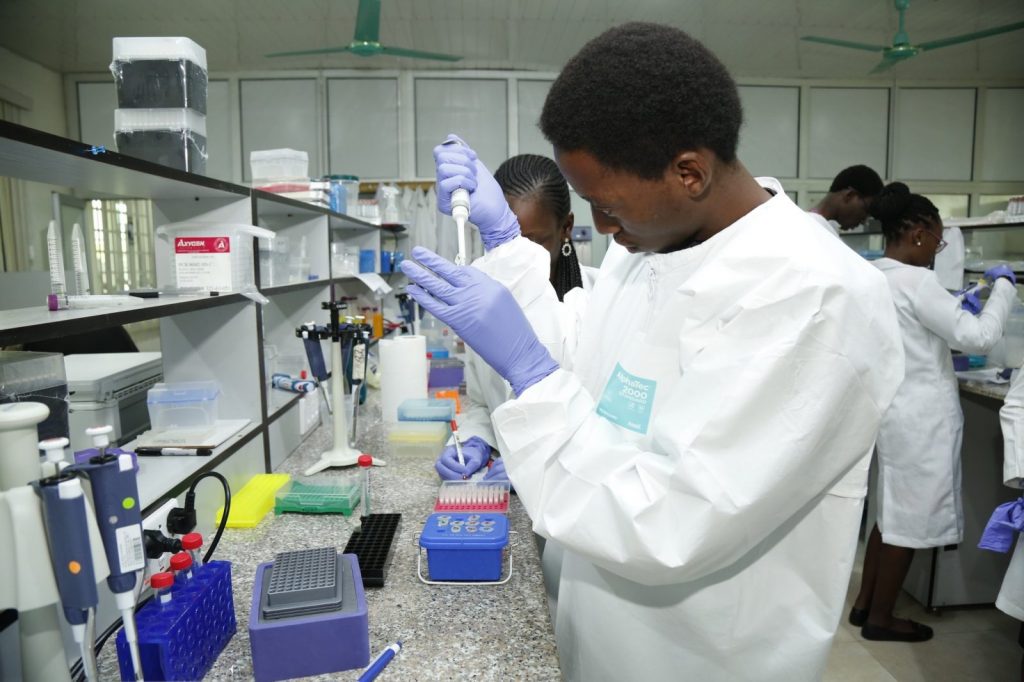 Black men and women who are lab scientist carrying out research in a lab