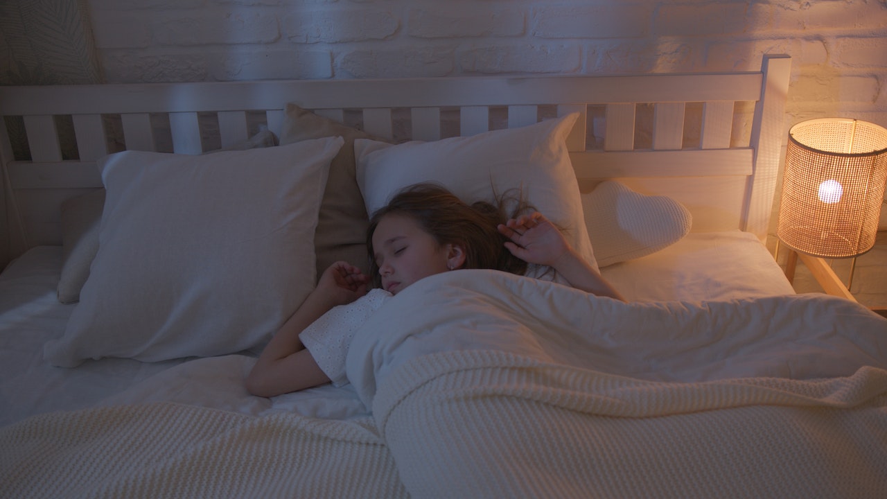 Girl Sleeping Near a Lamp