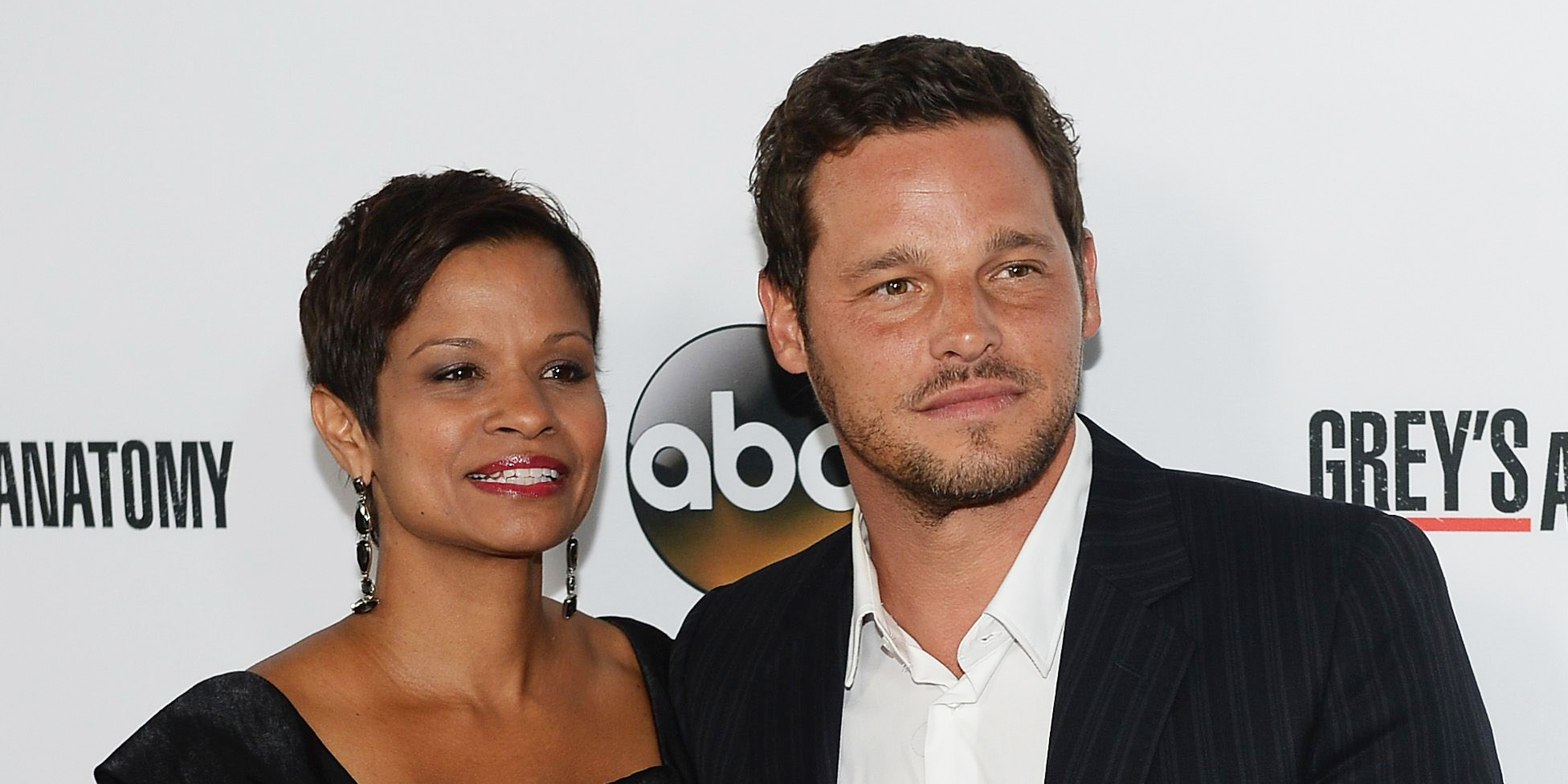 Keisha Chambers wearing a black outfit with her husband, Justin Chambers wearing suit