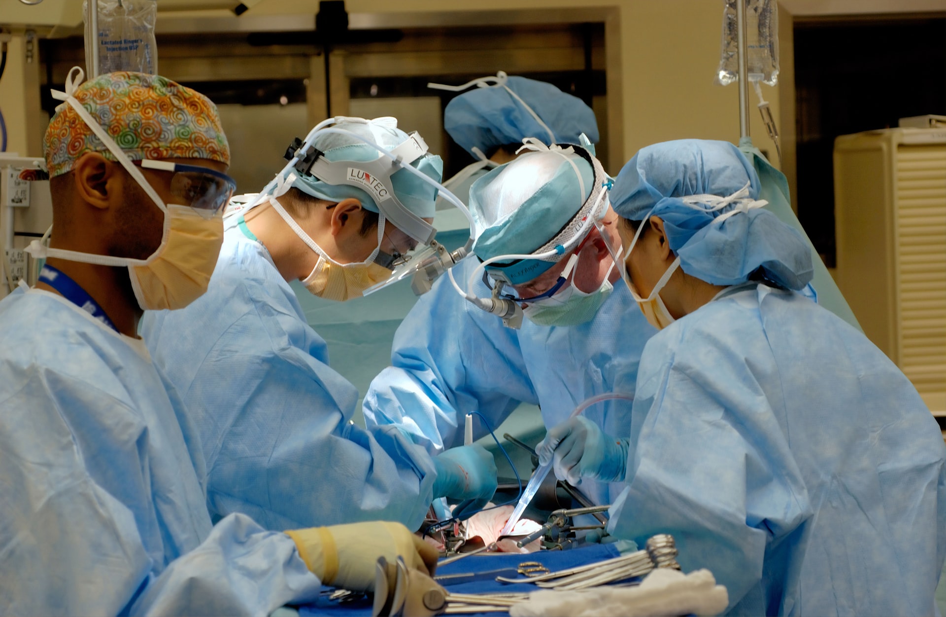 Multiple doctors performing surgery on a patient