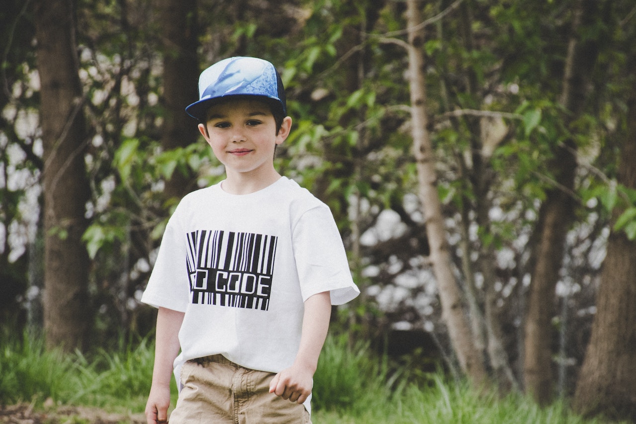 Boy In White Shirt And Blue Fitted Cap