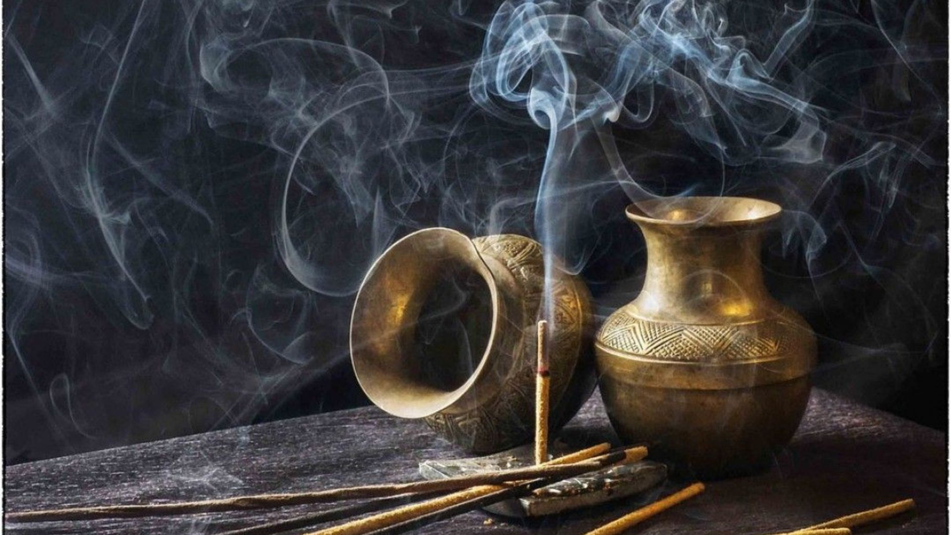 Two Golden Color Bowl With Smoke From A Stick