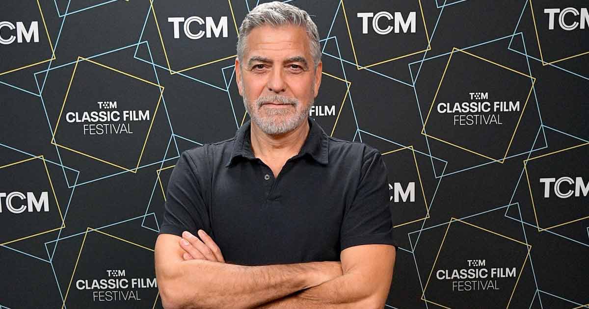 George Clooney wearing a black polo shirt