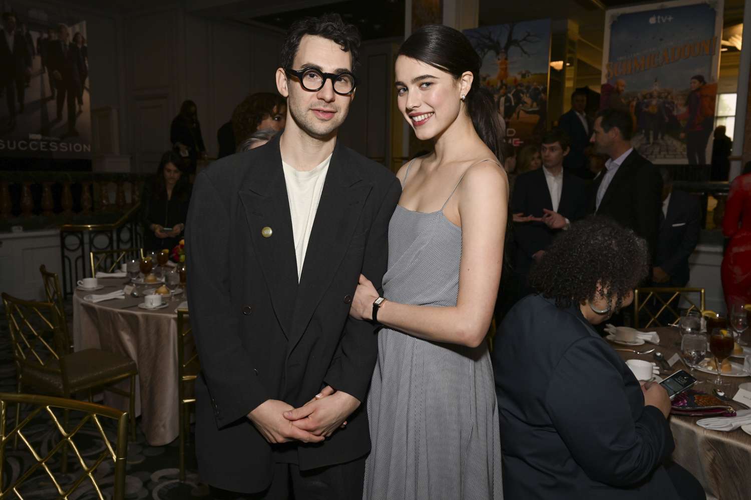 Jack Antonoff wearing a suit and Margaret Qualley wearing a gray dress