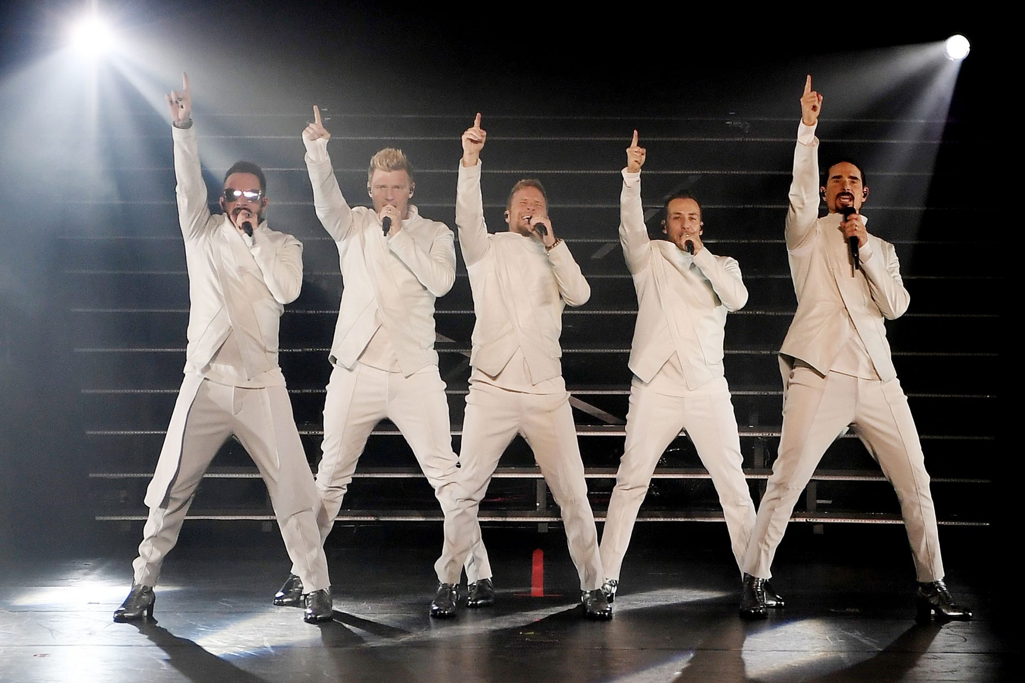 Backstreet Boys wearing white outfit while performing