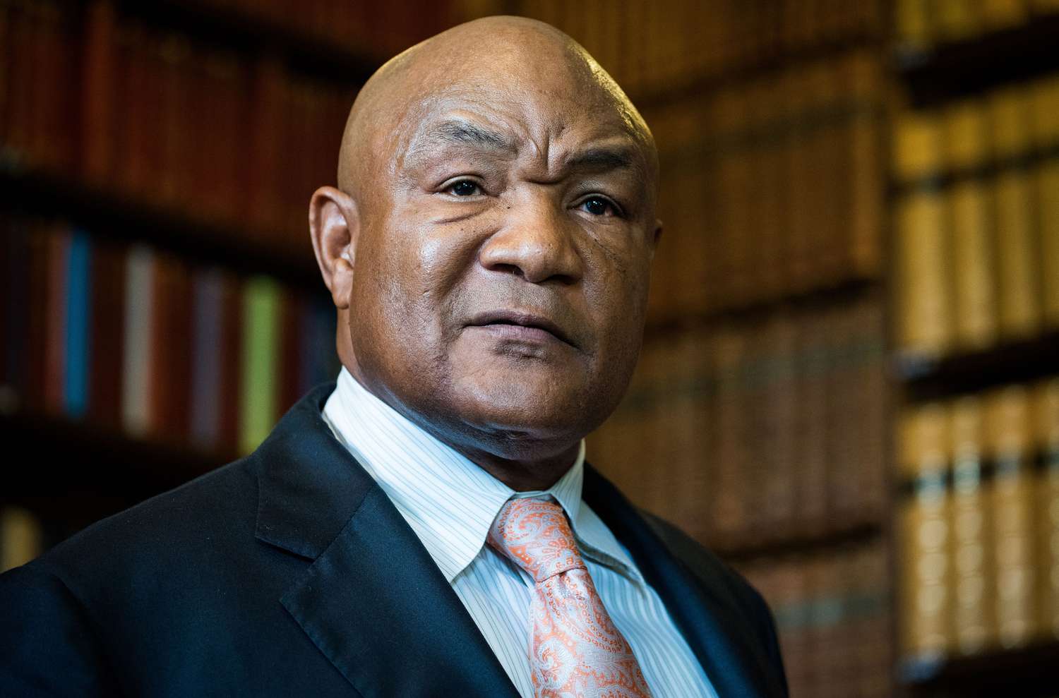 George Foreman wearing a black suit