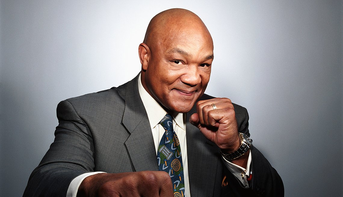 George Foreman wearing a gray suit