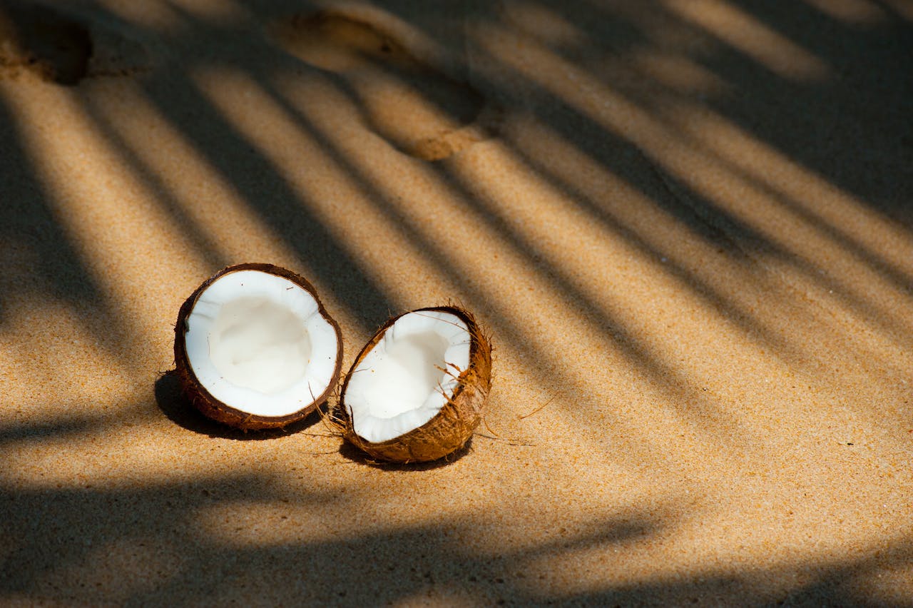 Opened Coconut on the Sand
