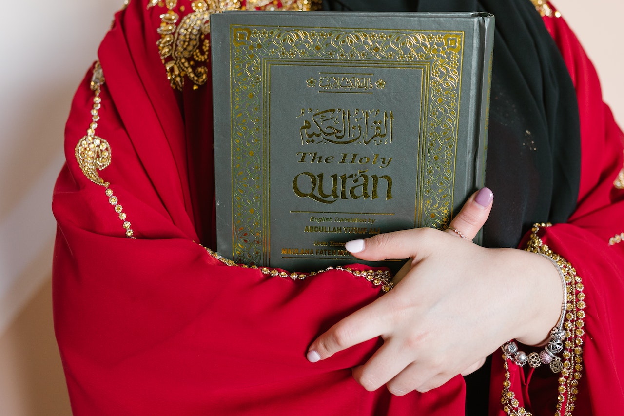 Person Holding A Holy Quran Book