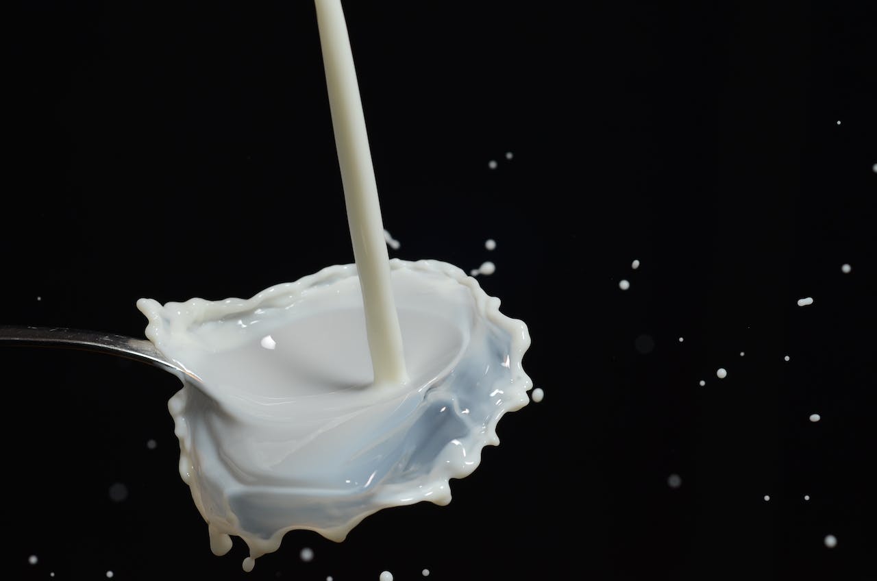 Milk pouring on Stainless Steel Spoon