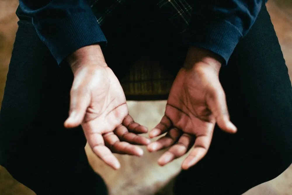 A person's hand open in prayers