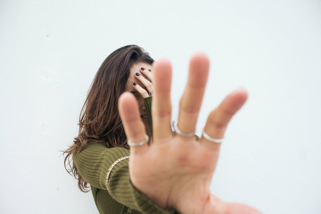Woman Covering Her Face with Her Hand
