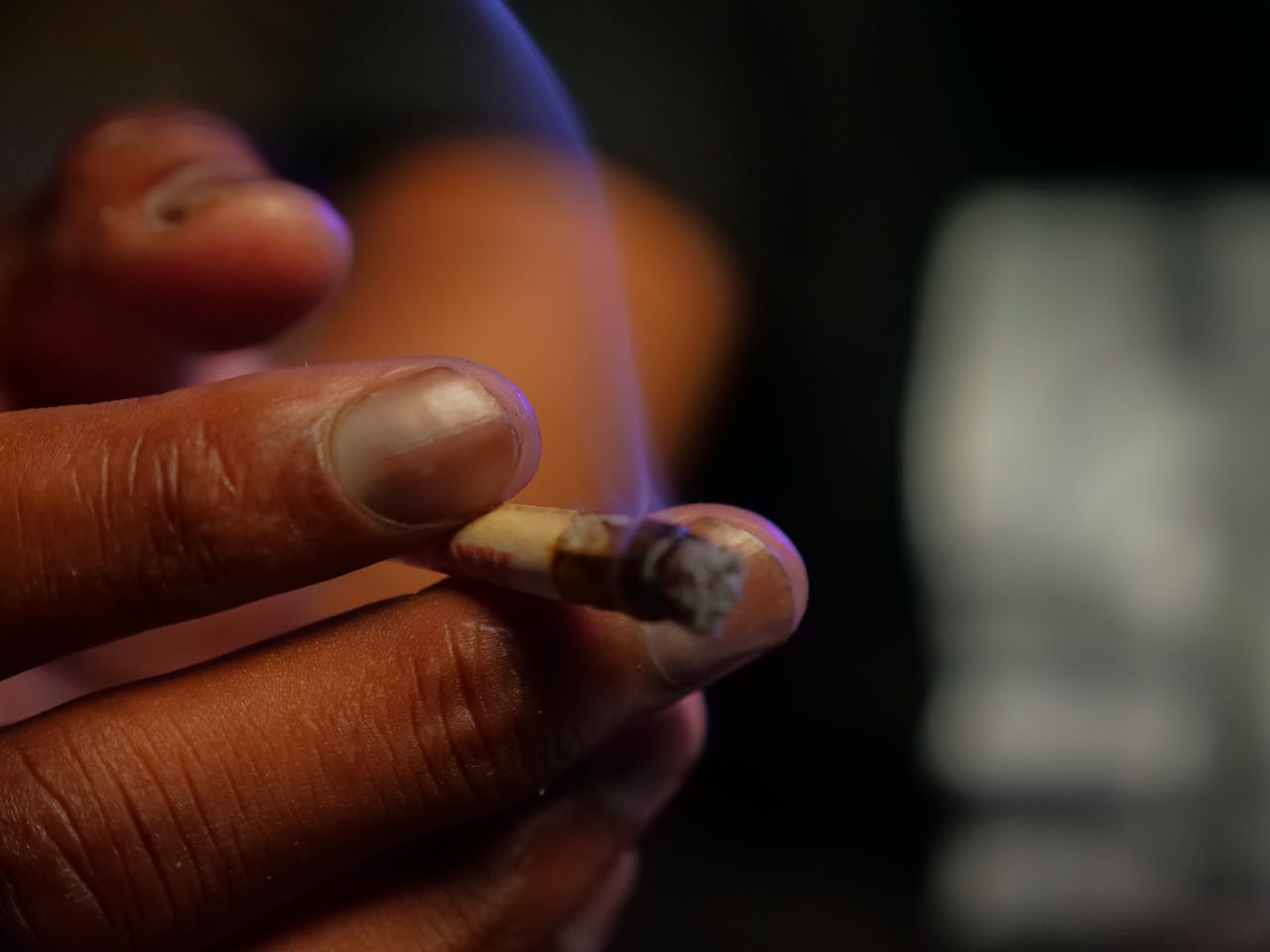 Close-Up of Person Holding Blunt
